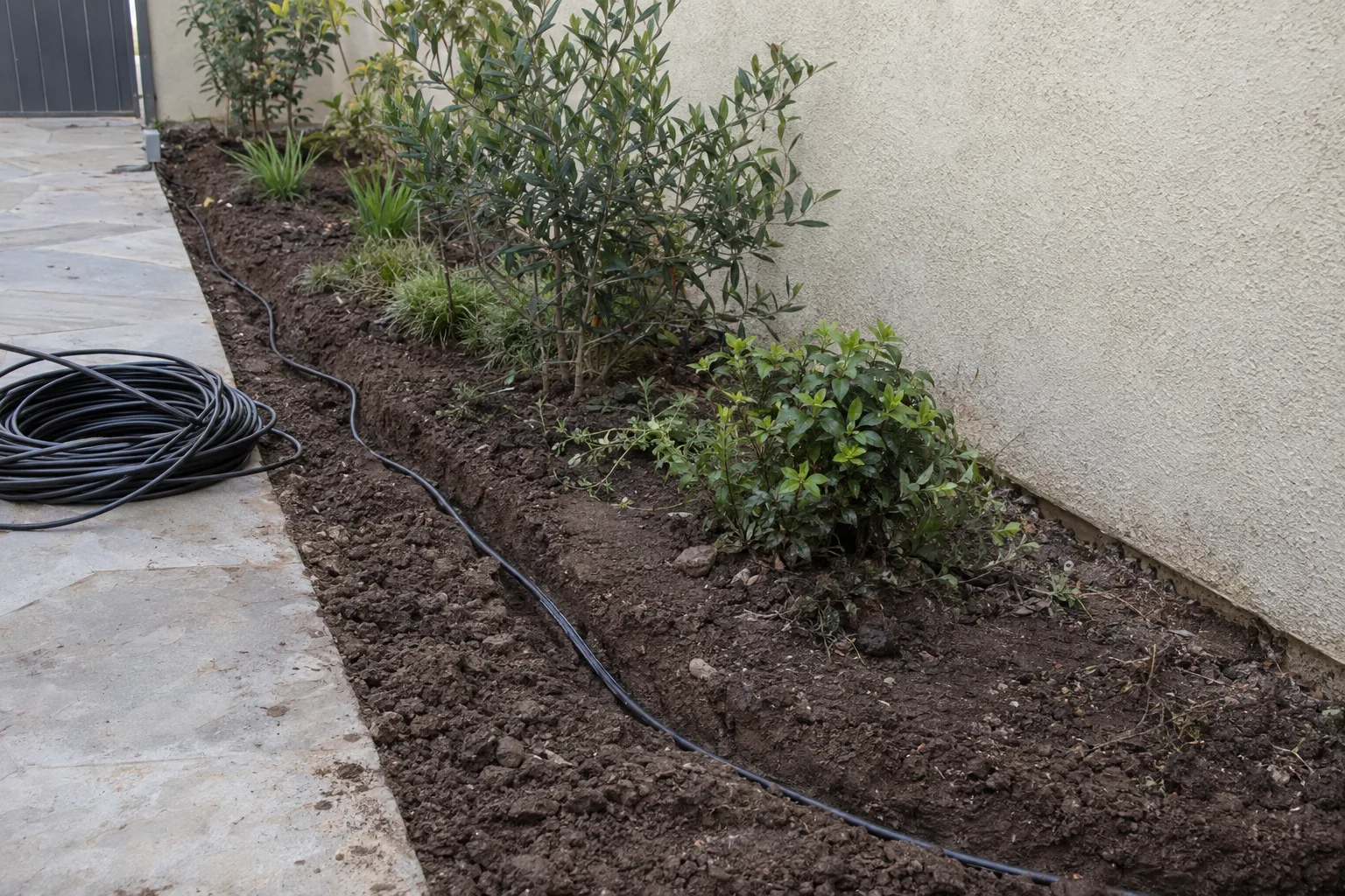 A prepared gravel and sand base for paver installation in a Pasadena backyard with compacted substrate ready for stone setting
