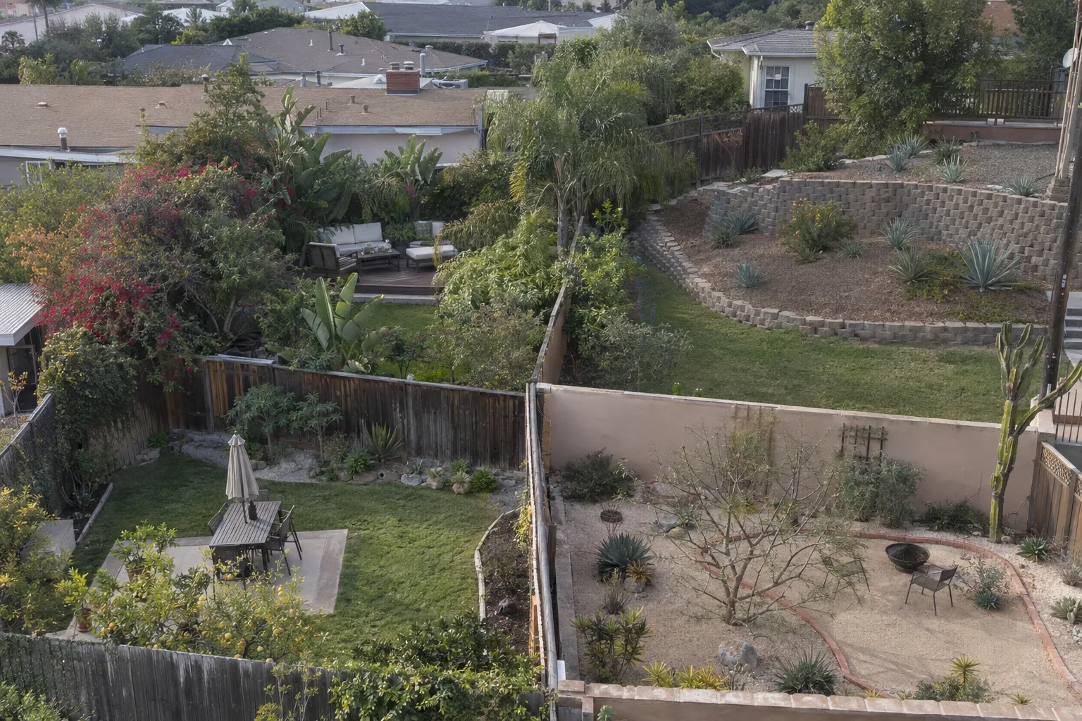 Aerial view of four adjacent residential backyards showing varied LA-region landscaping styles including coastal plantings, a hillside retaining wall, a desert-scape, and a flat lawn